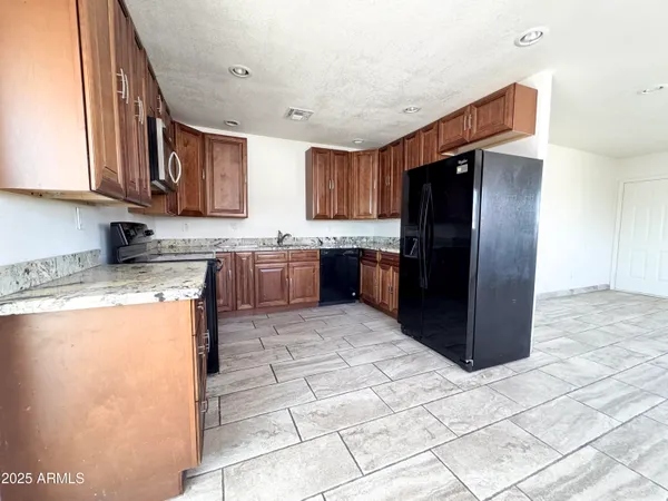a large kitchen with cabinets and stainless steel appliances