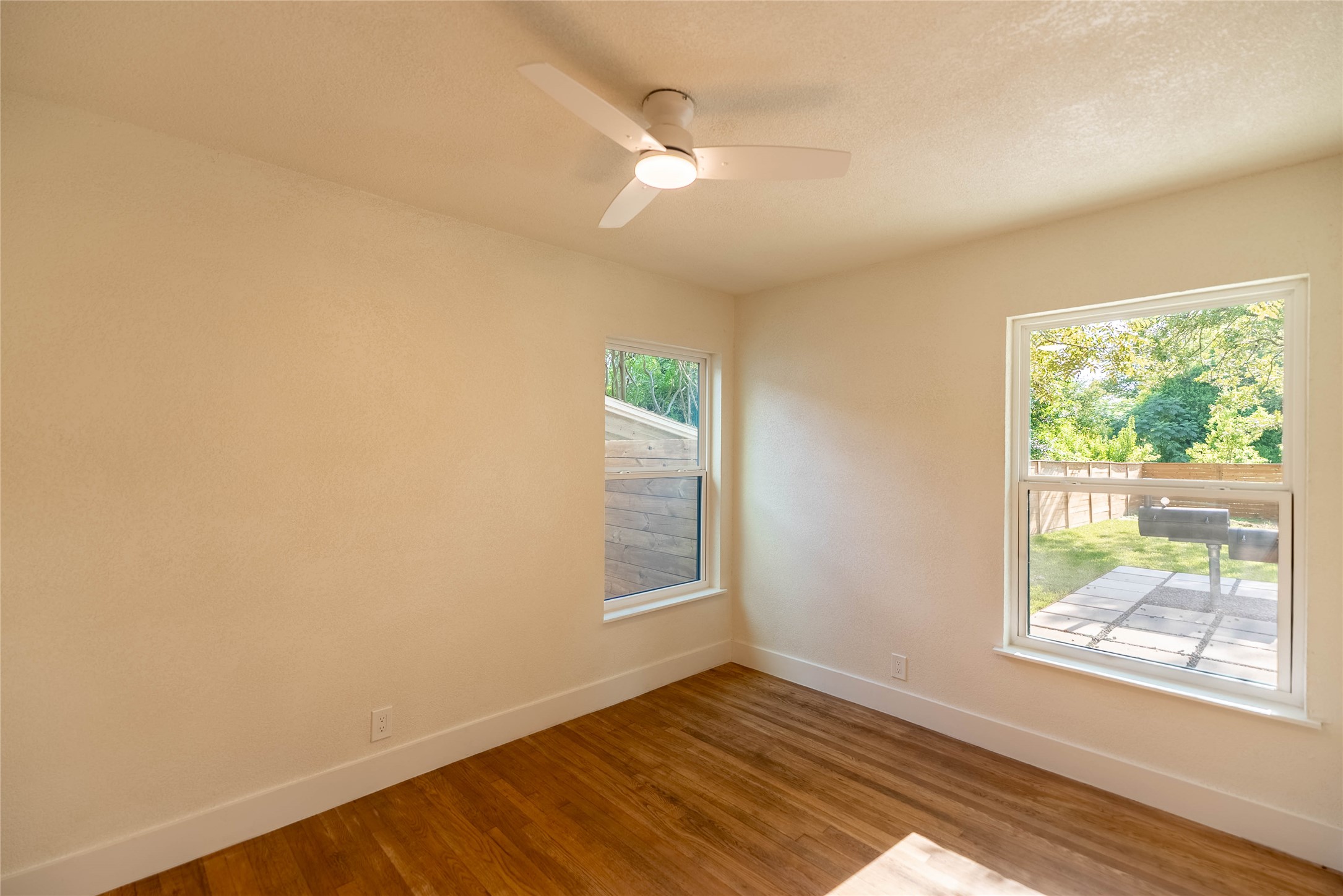 7700 Robalo Road Austin, TX 78757 - Photo 21 of 29 a view of an empty room with wooden floor and a window