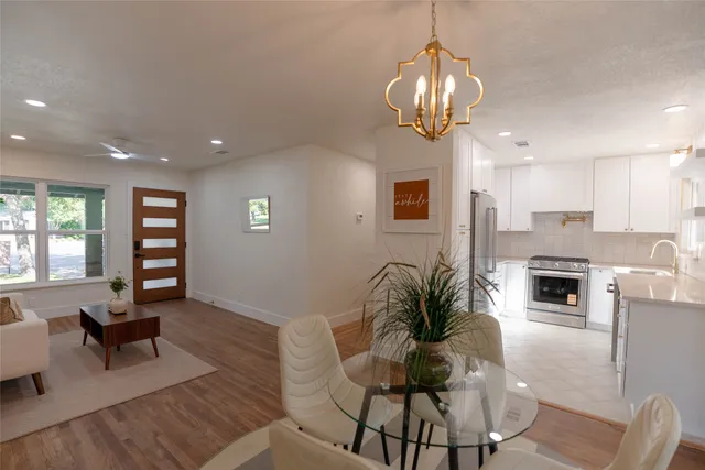 a living room with furniture and a chandelier