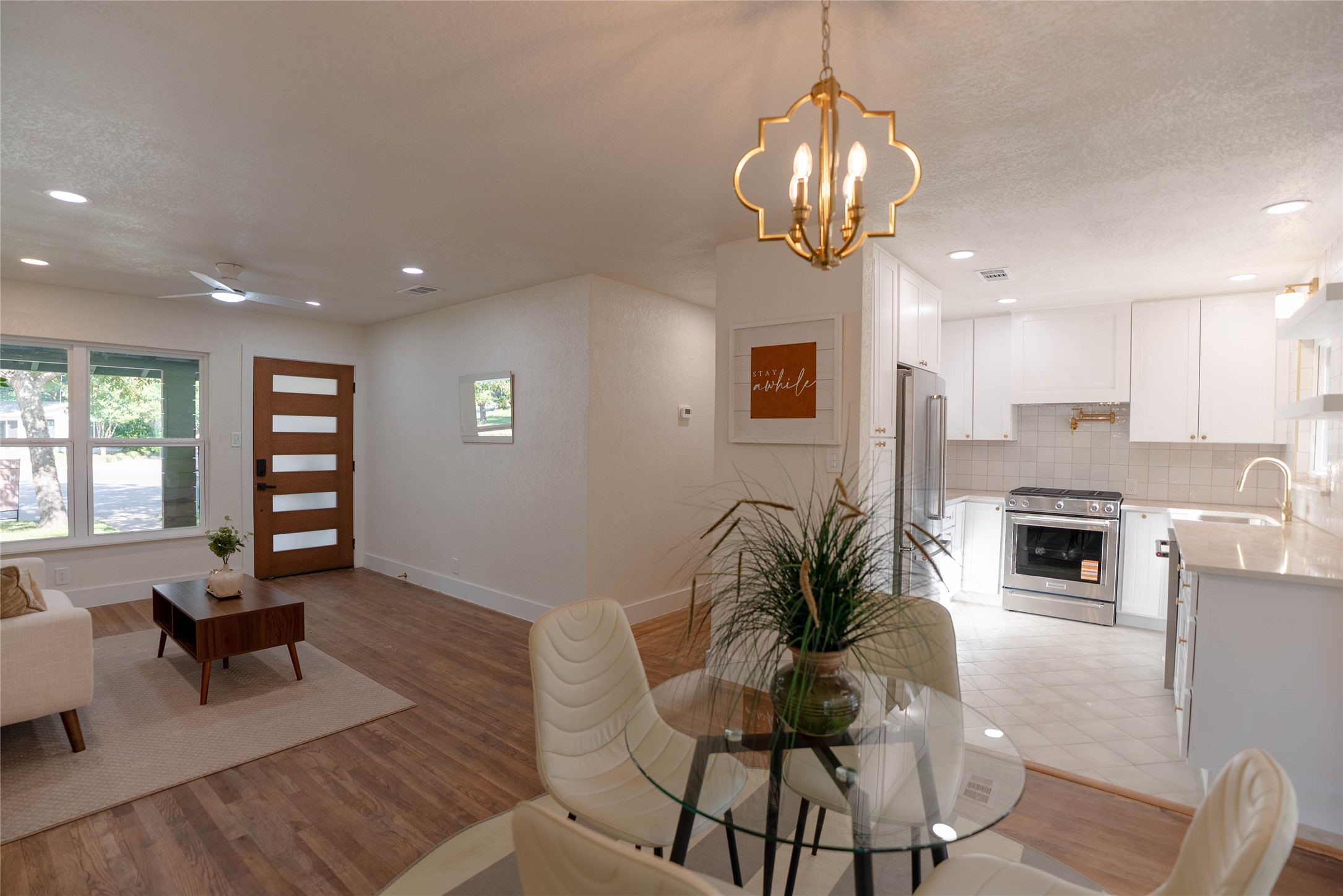 7700 Robalo Road Austin, TX 78757 - Photo 5 of 29 a living room with furniture and a chandelier