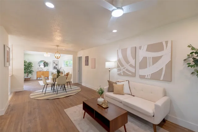 a living room with furniture and wooden floor