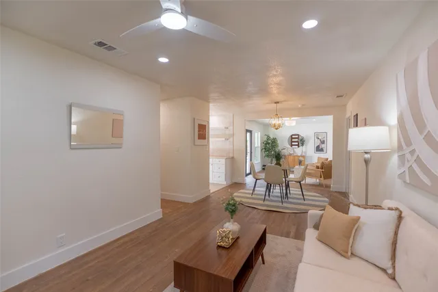 a living room with furniture and a wooden floor