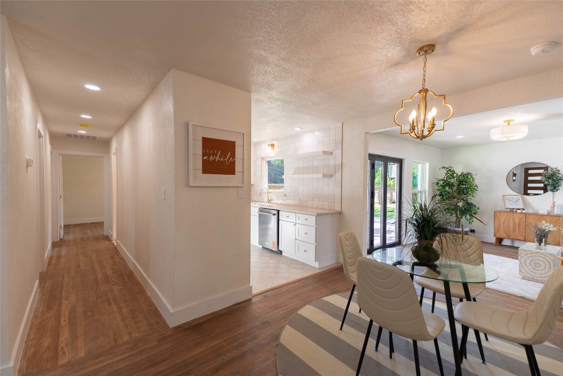 7700 Robalo Road Austin, TX 78757 - Photo 10 of 23 a view of a dining room with furniture window and wooden floor