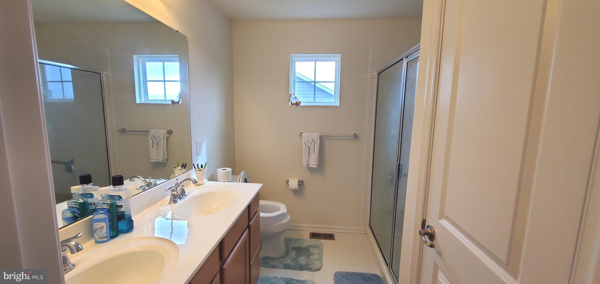 1999 Crossings Way Quakertown, PA 18951 - Photo 17 of 30 a en suite bathroom with a sink mirror and toilet