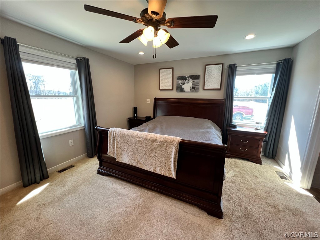 1214 Wilson Road Wilsons, VA 23894 - Photo 17 of 41 a bedroom with a bed dresser and a window