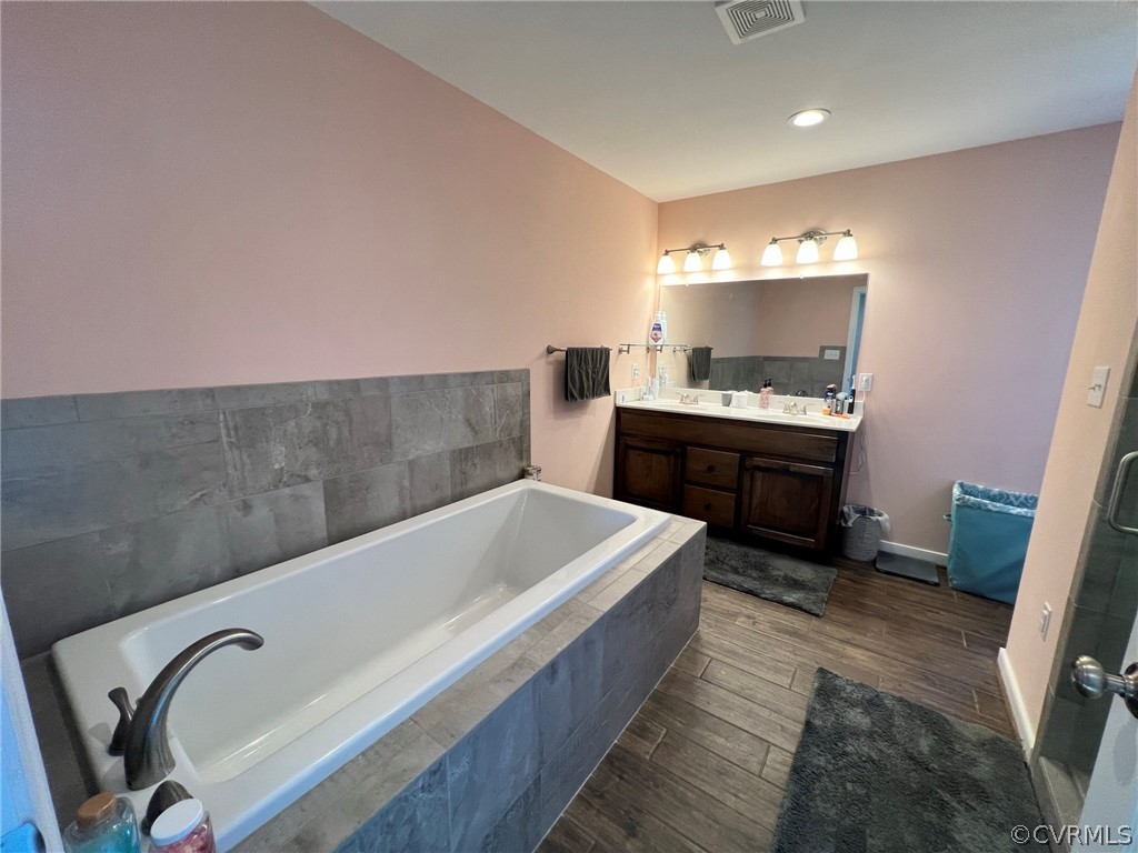 1214 Wilson Road Wilsons, VA 23894 - Photo 18 of 41 a spacious bathroom with a tub sink and mirror