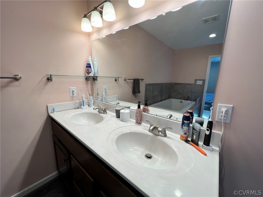 1214 Wilson Road Wilsons, VA 23894 - Photo 19 of 41 a bathroom with a sink and a mirror