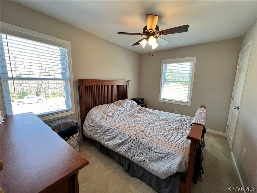 1214 Wilson Road Wilsons, VA 23894 - Photo 24 of 41 a bedroom with a bed window and a ceiling fan