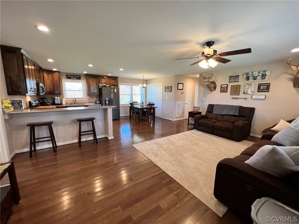 1214 Wilson Road Wilsons, VA 23894 - Photo 7 of 41 a living room with furniture kitchen view and a wooden floor