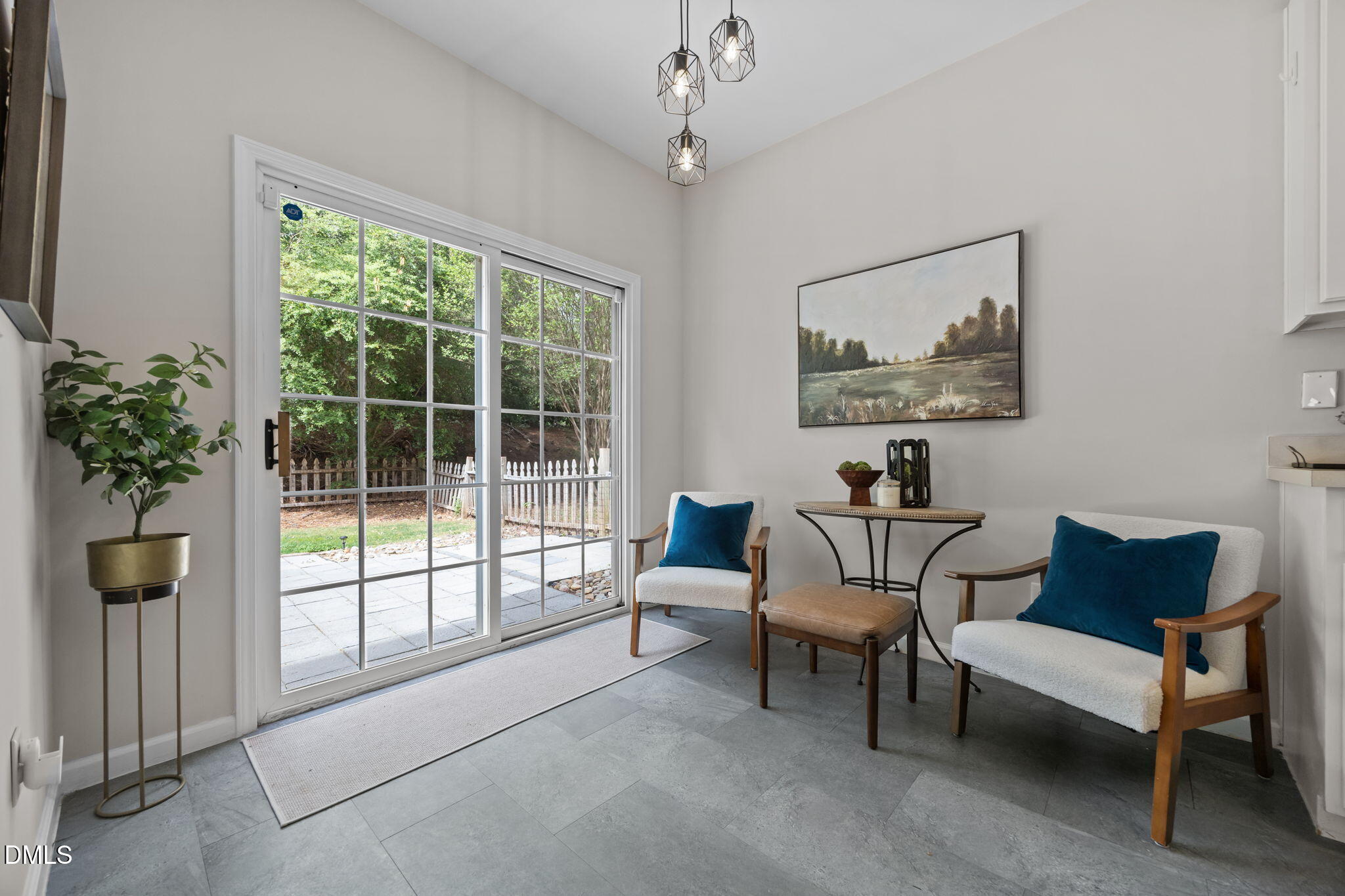 1003 Red Hat Lane Durham, NC 27713 - Photo 24 of 60 a living room with furniture and a large window with potted plants