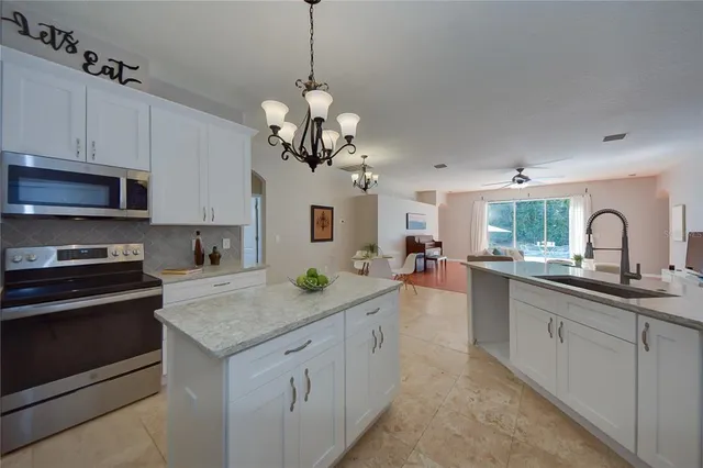a kitchen with a sink stainless steel appliances and cabinets