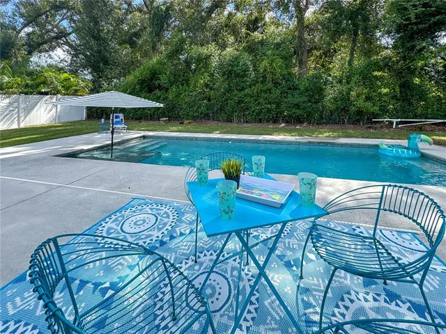 a view of a table and chairs under an umbrella