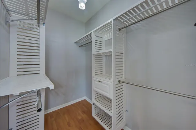 an empty room with ceiling fan and window