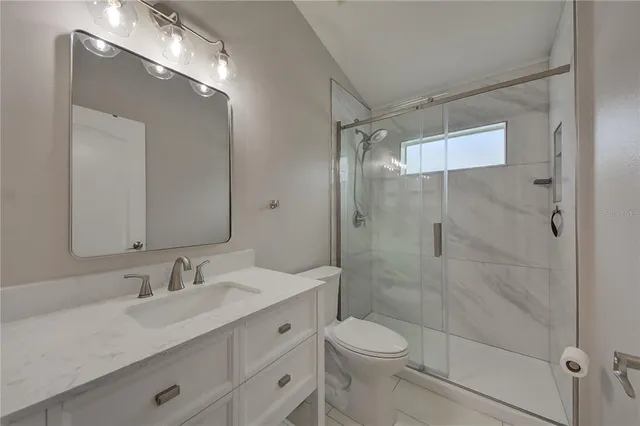 a view of a house with backyard swimming pool and sitting area