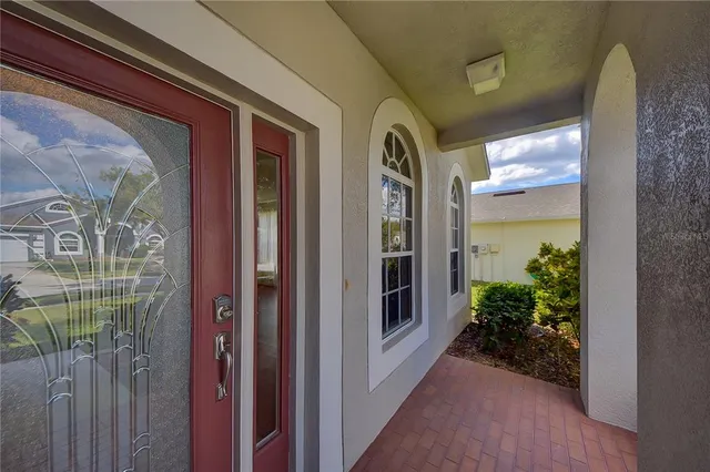 a front view of a hallway with chandelier