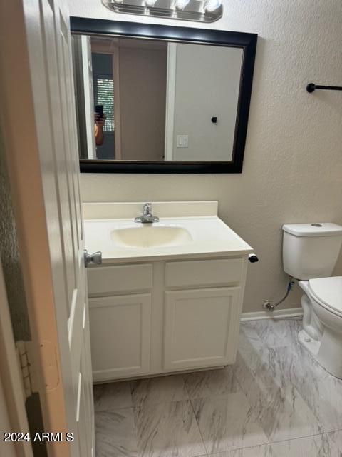 1336 East Mountain View Road, Unit 202 Phoenix, AZ 85020 - Photo 21 of 23 a bathroom with a toilet sink and mirror