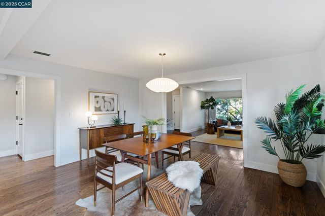 a living room with furniture potted plant and a wooden floor