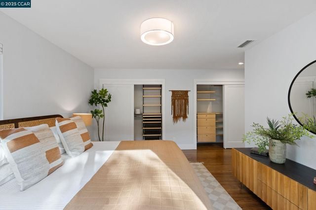 a bedroom with a bed and a potted plant