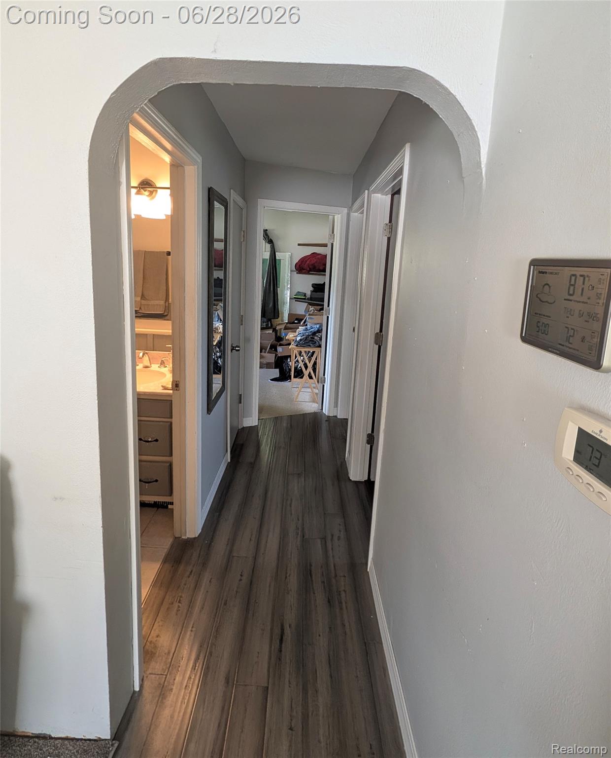 4456 East Coldwater Road Flint, MI 48506 - Photo 15 of 35 Hallway featuring wood-finish flooring, light gray wall paint, and an arched doorway