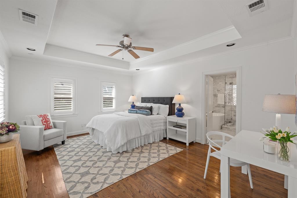 5242 Merrimac Avenue Dallas, TX 75206 - Photo 15 of 25 Bedroom featuring a raised ceiling, wood finished floors, crown molding, and a ceiling fan