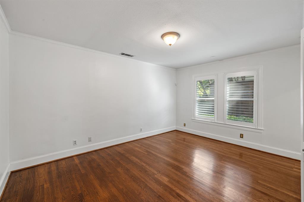 5242 Merrimac Avenue Dallas, TX 75206 - Photo 22 of 25 Empty room with wood finished floors and ornamental molding