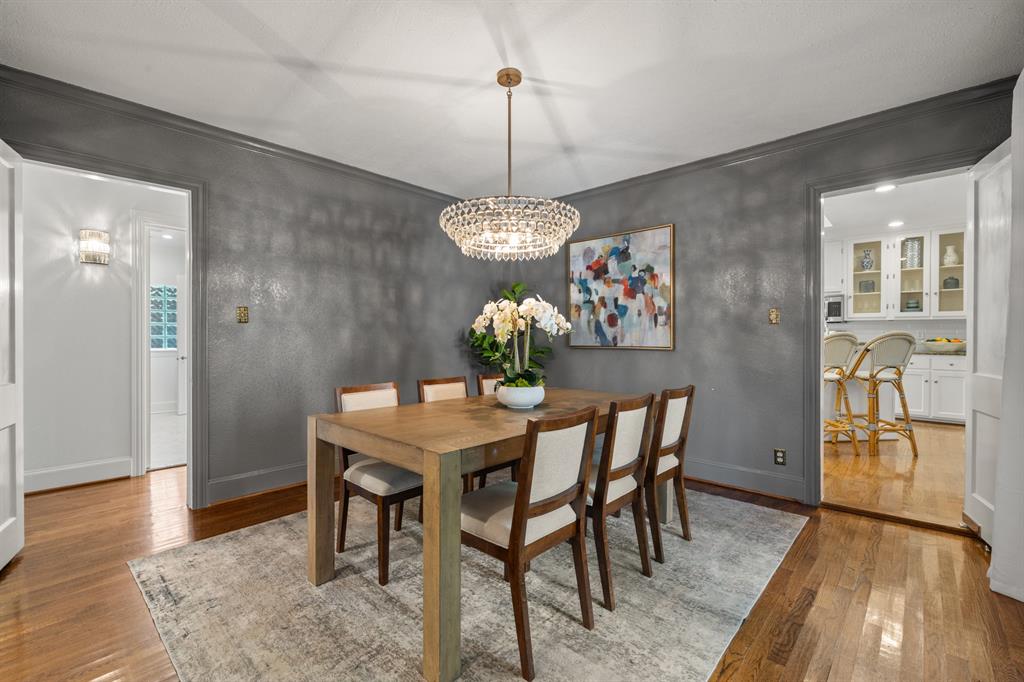 5242 Merrimac Avenue Dallas, TX 75206 - Photo 9 of 25 Dining space featuring light wood-style floors, crown molding, and a chandelier