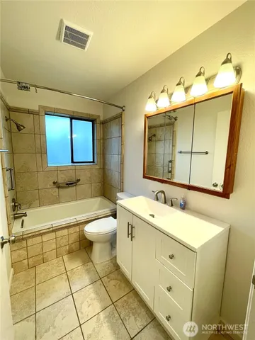a view of a room with wooden floor and white walls
