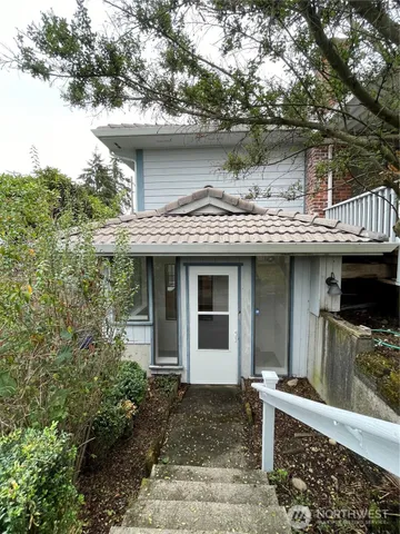 a view of house with a wooden fence
