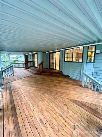 a bed sitting in a spacious bedroom next to a window