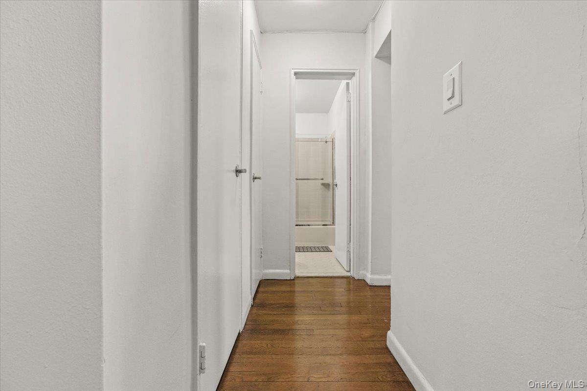 6 Birchwood Court, Unit 5B Mineola, NY 11501 - Photo 12 of 13 a view of a hallway with the wooden floor