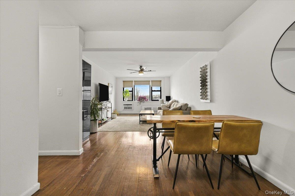 6 Birchwood Court, Unit 5B Mineola, NY 11501 - Photo 2 of 13 a view of a dining room with furniture and wooden floor