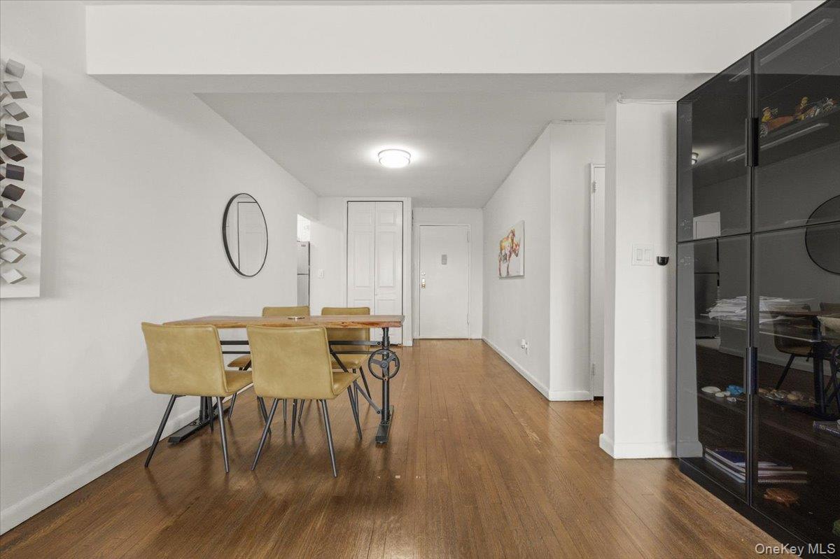 6 Birchwood Court, Unit 5B Mineola, NY 11501 - Photo 5 of 13 a view of a dining room with furniture and wooden floor