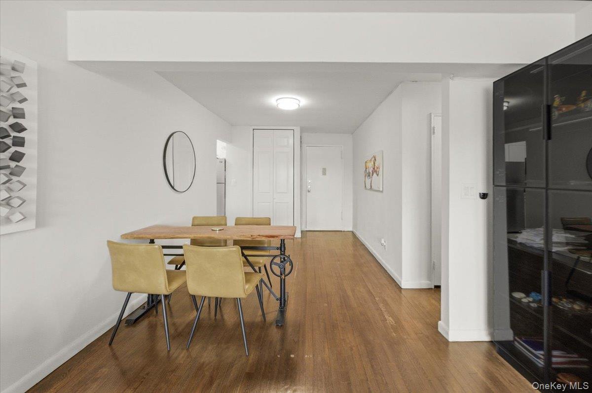 6 Birchwood Court, Unit 5B Mineola, NY 11501 - Photo 6 of 13 a view of a dining room with furniture and wooden floor
