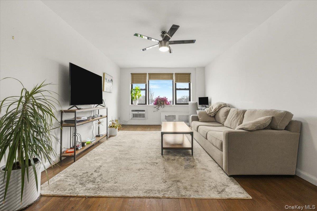 6 Birchwood Court, Unit 5B Mineola, NY 11501 - Photo 7 of 13 a living room with furniture and a flat screen tv
