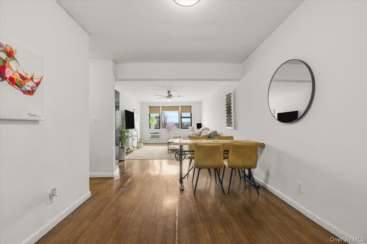 6 Birchwood Court, Unit 5B Mineola, NY 11501 - Photo 8 of 13 a view of a dining room with furniture and wooden floor