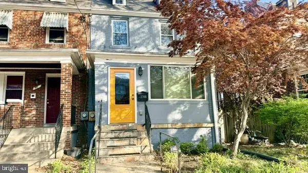 front view of a house with a tree