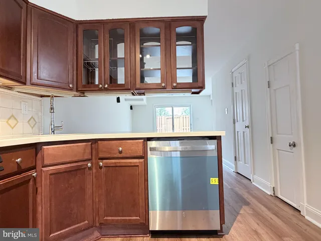a kitchen with granite countertop cabinets stainless steel appliances and wooden floor