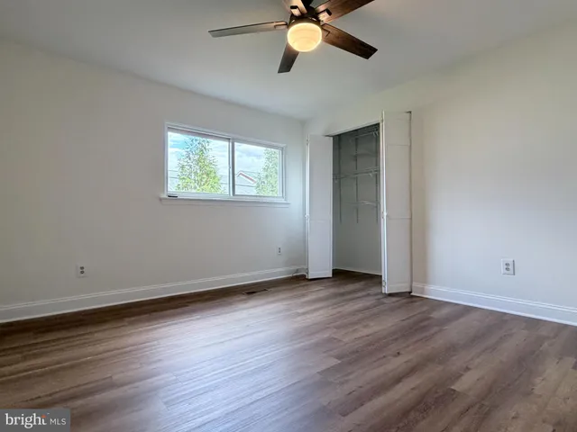 a view of an empty room and wooden floor