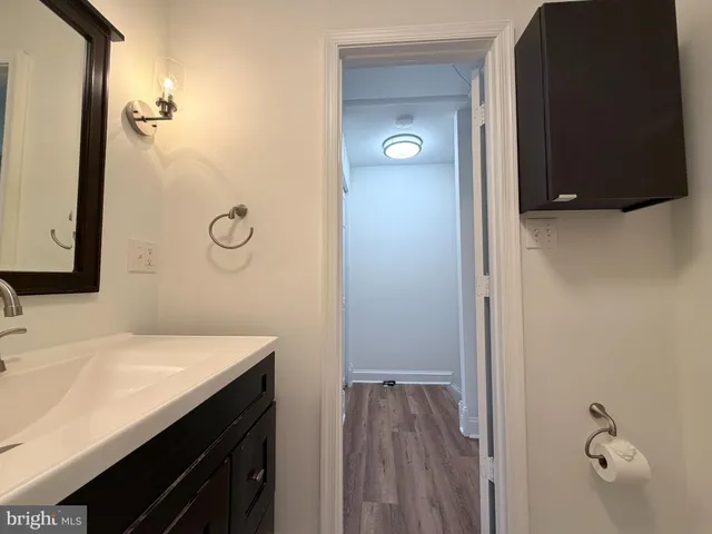 a bathroom with a sink vanity and mirror