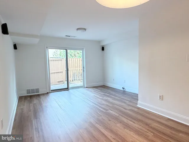 a view of a kitchen with a sink and a refrigerator