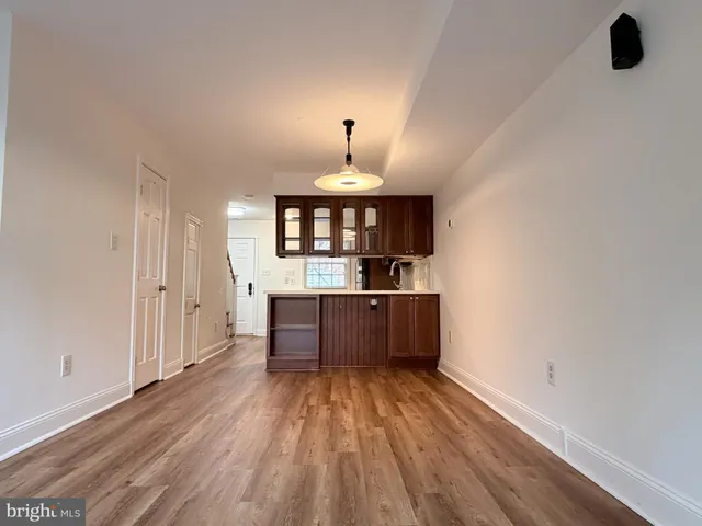 a view of kitchen with wooden floor and electronic appliances