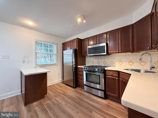 a kitchen with a sink stove and microwave