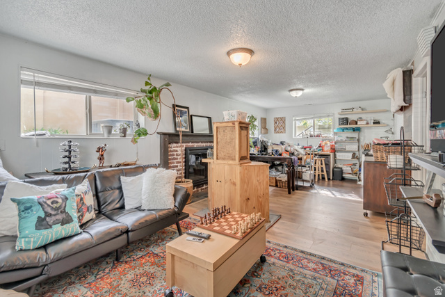 7470 Ramanee Drive Midvale, UT 84047 - Photo 24 of 29 Flex space can be a large bedroom with walk in closet or as a family room, a textured ceiling, and a brick fireplace