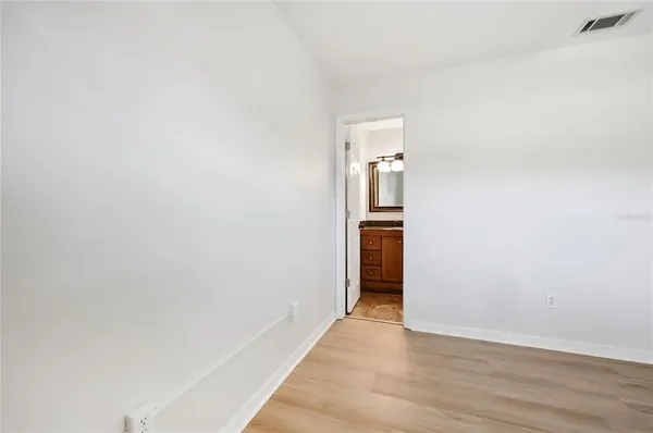 a view of hallway with wooden floor