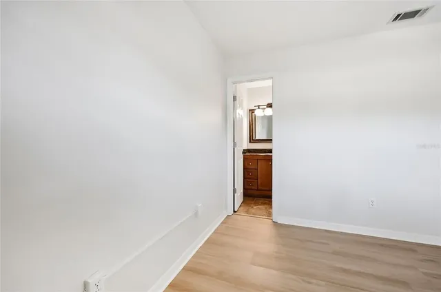 a view of hallway with wooden floor