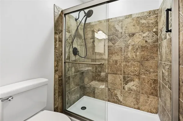 a bathroom with a shower and a toilet