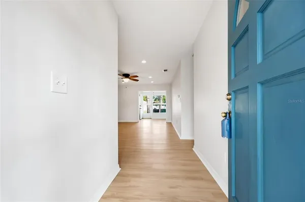 a view of a hallway with wooden floor