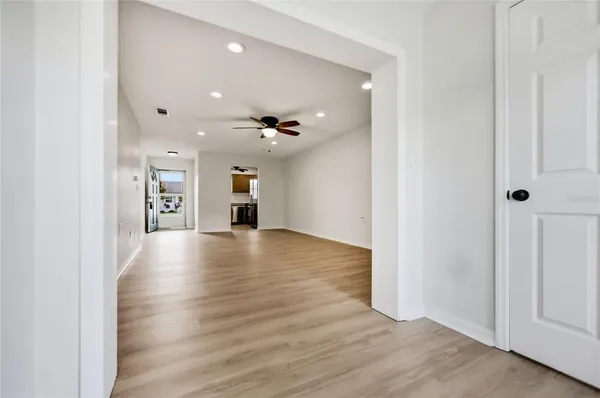 a view of empty room with wooden floor