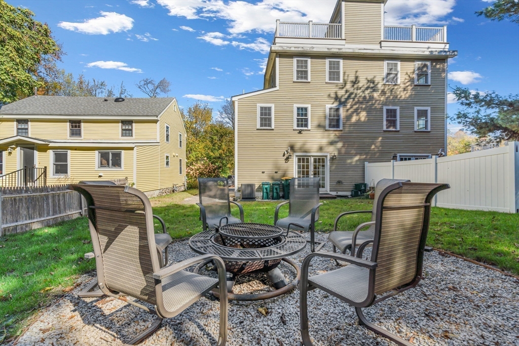 37 Water Street, Unit 37 Concord, MA 01742 - Photo 26 of 29 a view of a patio with couches chairs and a fire pit