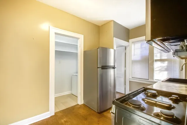 a kitchen with a refrigerator and a stove